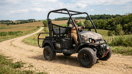 Man driving camo Tracker EV on rural dirt road — Tracker EV clicking when accelerating, what it means and how to fix the CV joint issue.