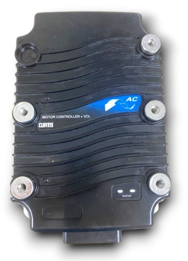 A top-down view of a black Curtis AC motor controller with a ribbed heat-sink design, featuring mounting points and a status indicator light.