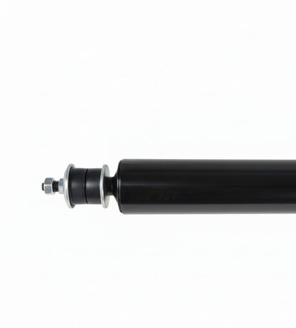 Displays a section of a black shock absorber, featuring its mounting bolt, washers, and rubber bushing.